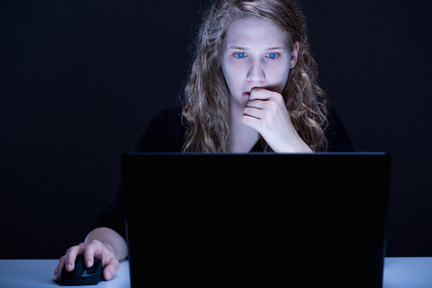 woman looking concerned online about data privacy