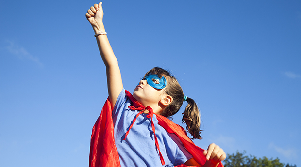 Little seven years old girl with a handmade superhero disguise.